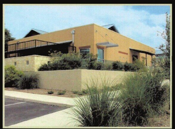 Corporate campus building with native grasses and shrubs in the foreground